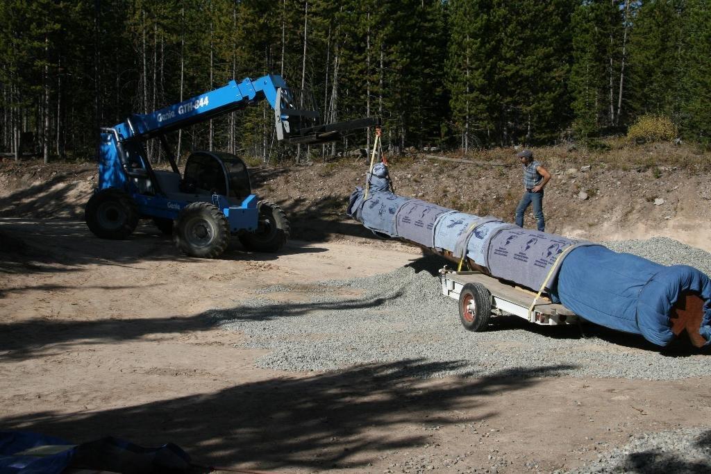 Totem pole being moved by a machine